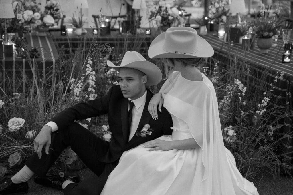 ralph lauren inspired austin wedding couple sits by their reception table design