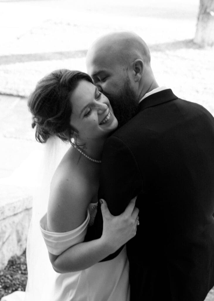 bride and groom snuggle during portraits