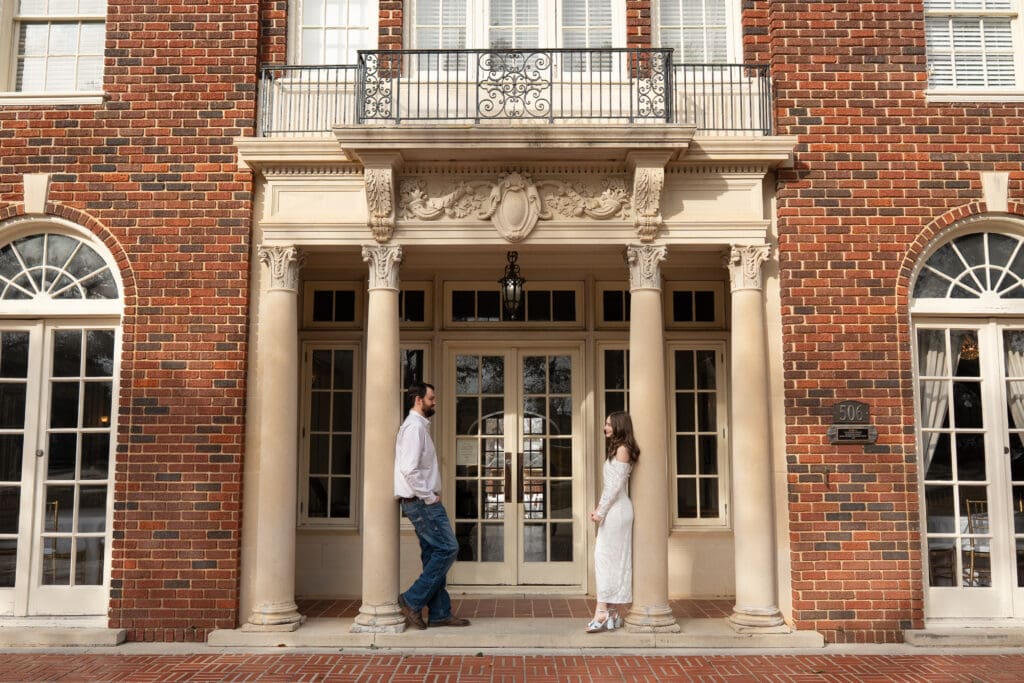 Macy and Trevor posing romantically in Engagement photos at Astin Mansion in College Station