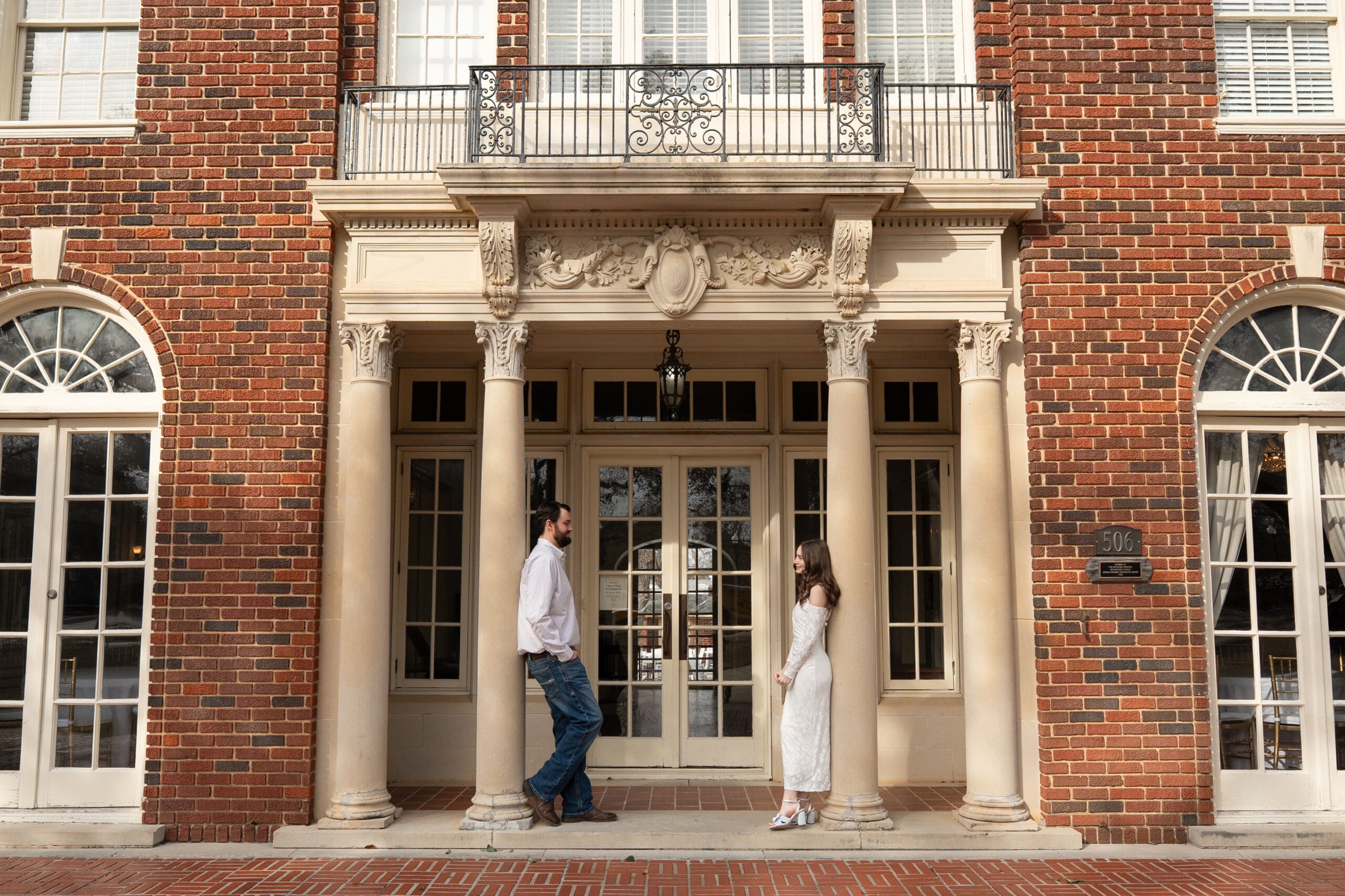 Macy and Trevor posing romantically in Engagement photos at Astin Mansion in College Station