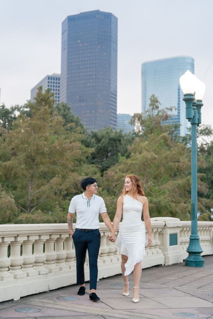 Engagement photos at Sabine Street Bridge with Houston skyline at sunrise